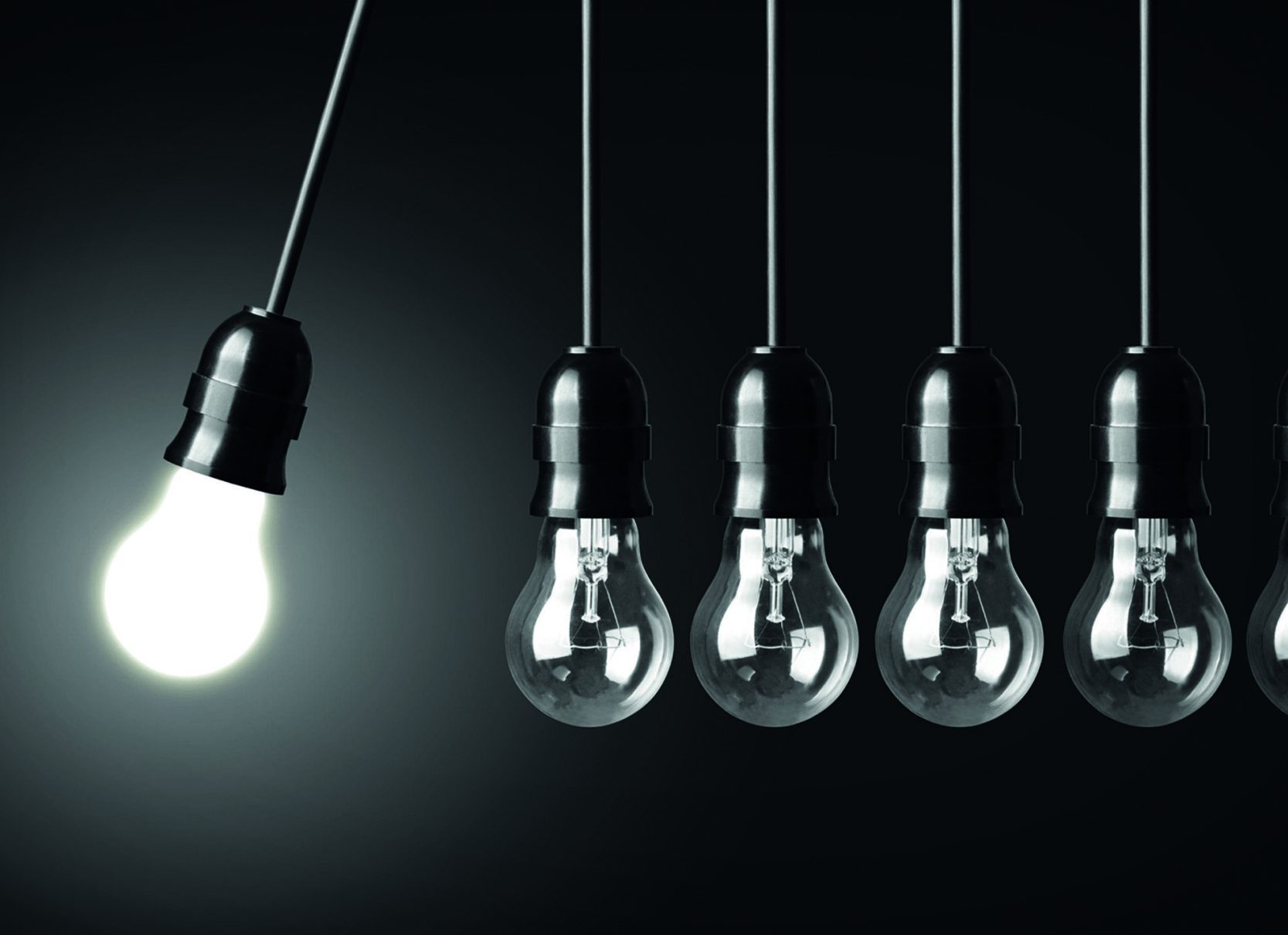Idea concept on black. Perpetual motion with light bulbs